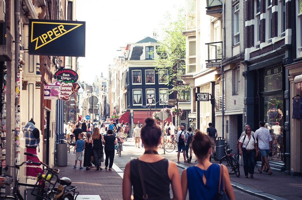 People walk through the Nine Streets in Amsterdam