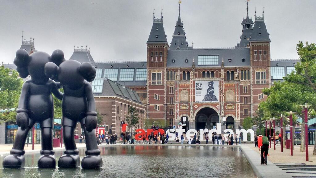 A photo of the Rijksmuseum and the Amsterdam sign in Museumplein in Amsterdam